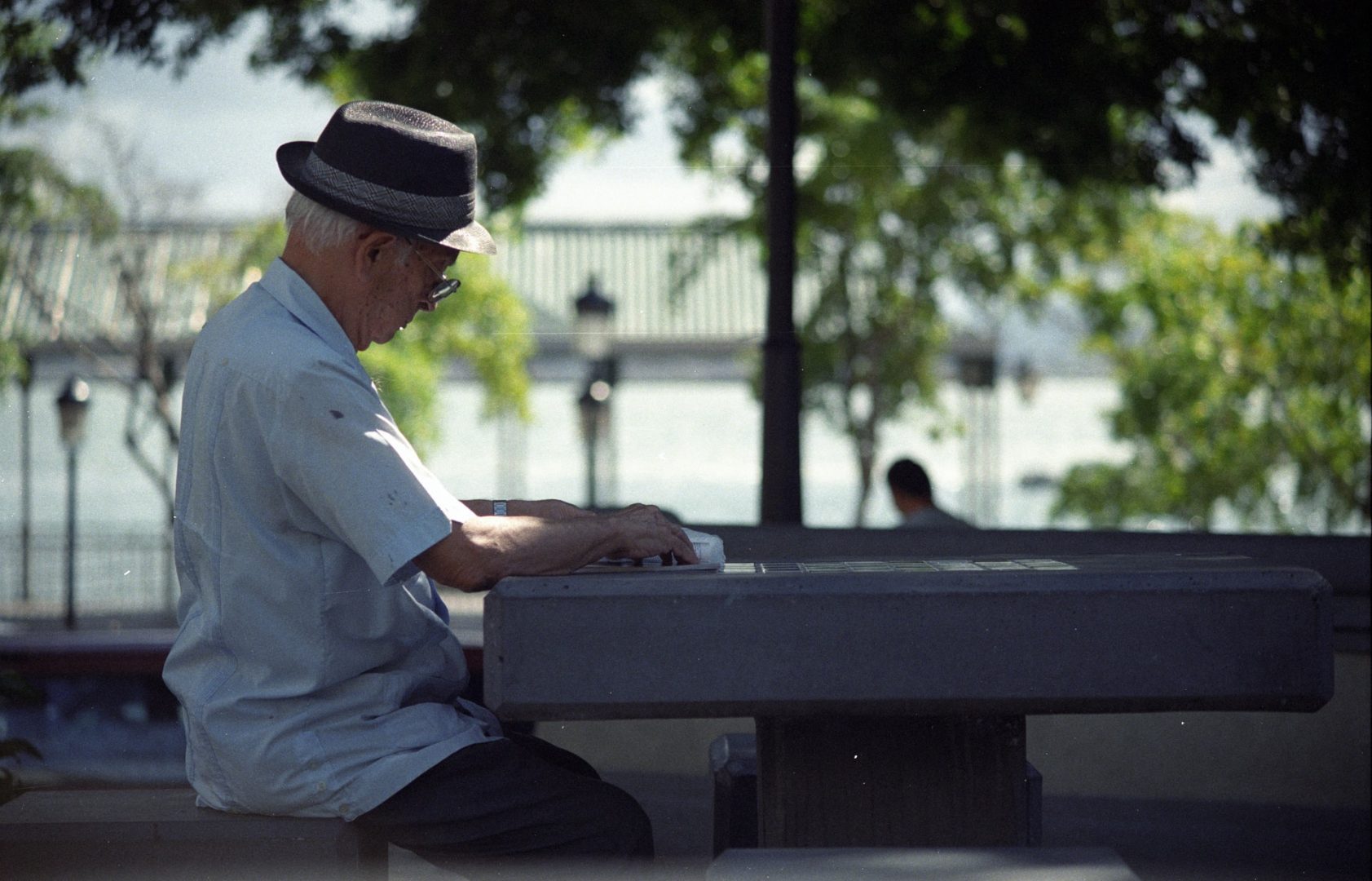Elderly man reading on a chess table