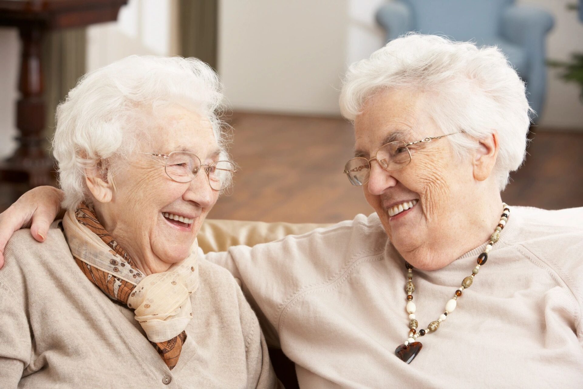 Two elderly women laughing together