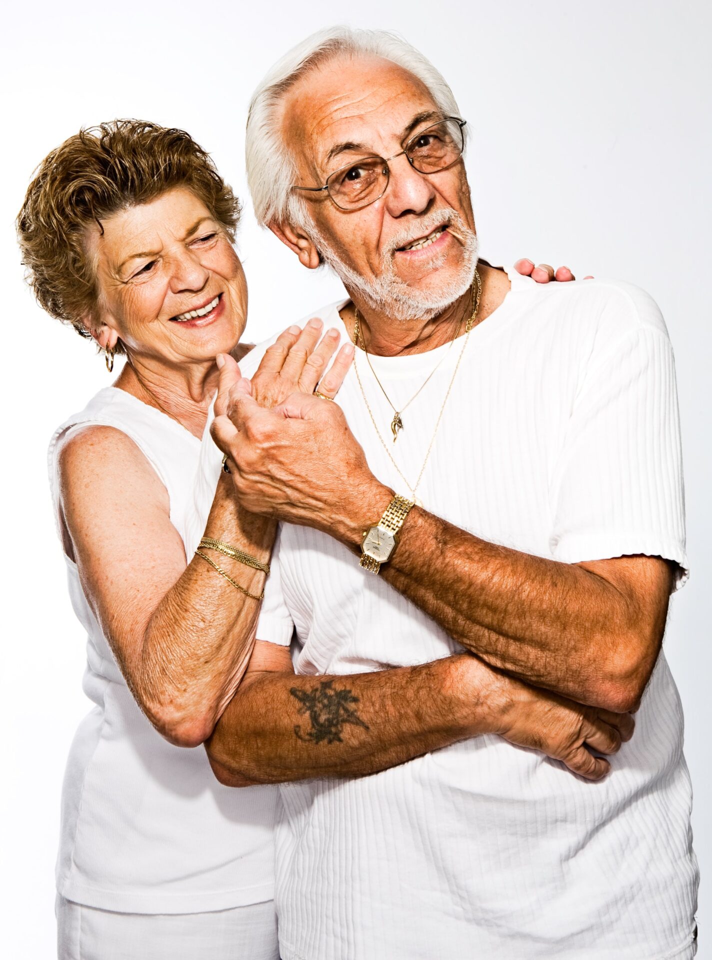 Happy elderly couple in white