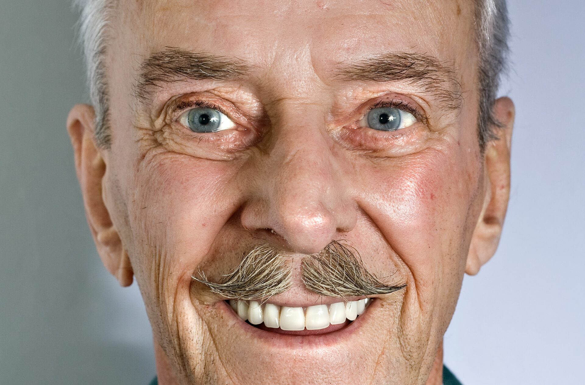 Smiling elderly man with a mustache